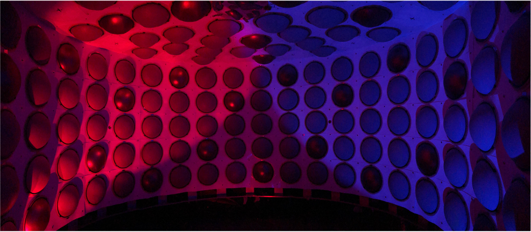 Interior of the CCM detector illuminated red and blue